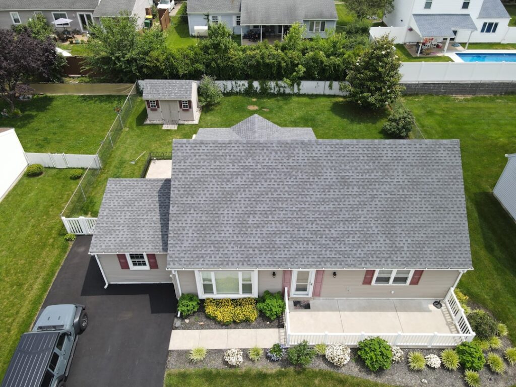 A row of residential homes with different roofing types including asphalt, slate, and metal.