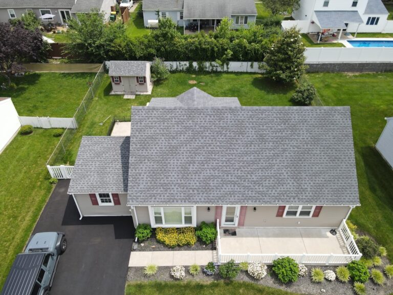 A row of residential homes with different roofing types including asphalt, slate, and metal.
