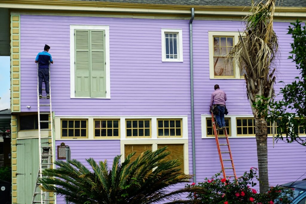 A residential street with homes showing a variety of well-chosen exterior paint colors in natural daylight.